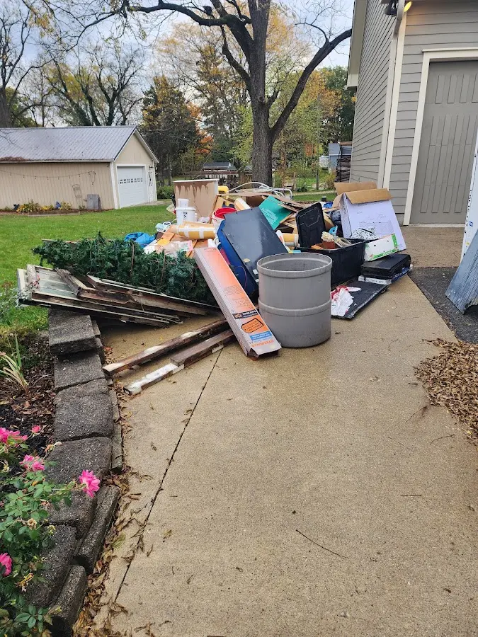 Dumpster being loaded with debris for Estate Cleanout Dumpster Rental in Manassas